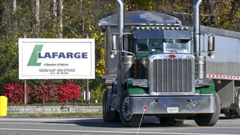 A lorry leaves the Lafarge cement plant in Ravena, NY. The French company has been ordered to stand trial for financing terrorism, accused of paying the Islamic State group in exchange for permission to keep open a plant in Syria in 2014.