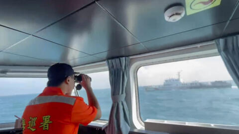 In this screen grab from video released by the Taiwan Coast Guard, a member of the Taiwan Coast Guard monitors a China Coast Guard boat as it passes near the coast of Matsu islands, Taiwan on Monday,