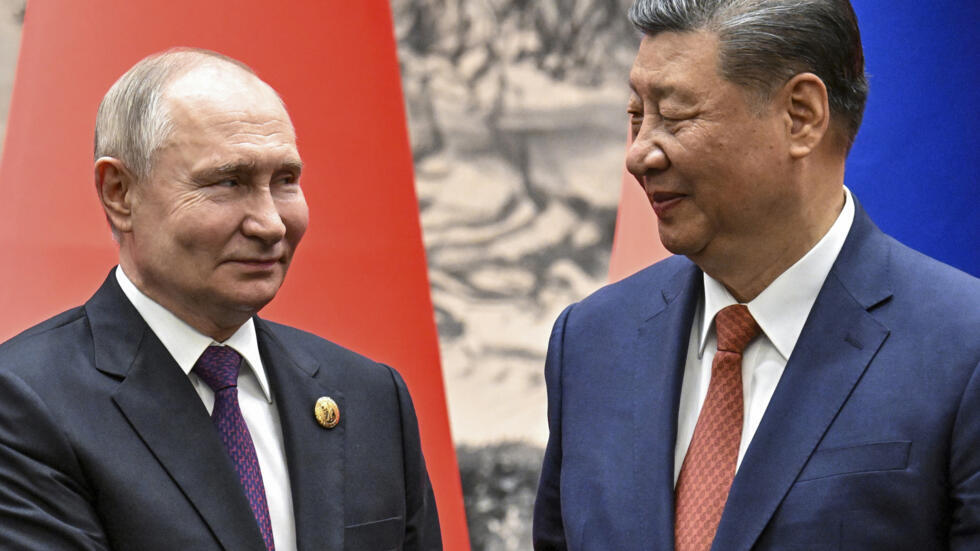 Chinese President Xi Jinping, right, and Russian President Vladimir Putin look toward each other as they shake hands prior to their talks in Beijing, China, May 16, 2024.