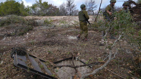 Israeli soldiers display what they say is an entrance to a Hezbollah tunnel found during their ground operation in southern Lebanon, near the border with Israel, Sunday, Oct. 13, 2024.