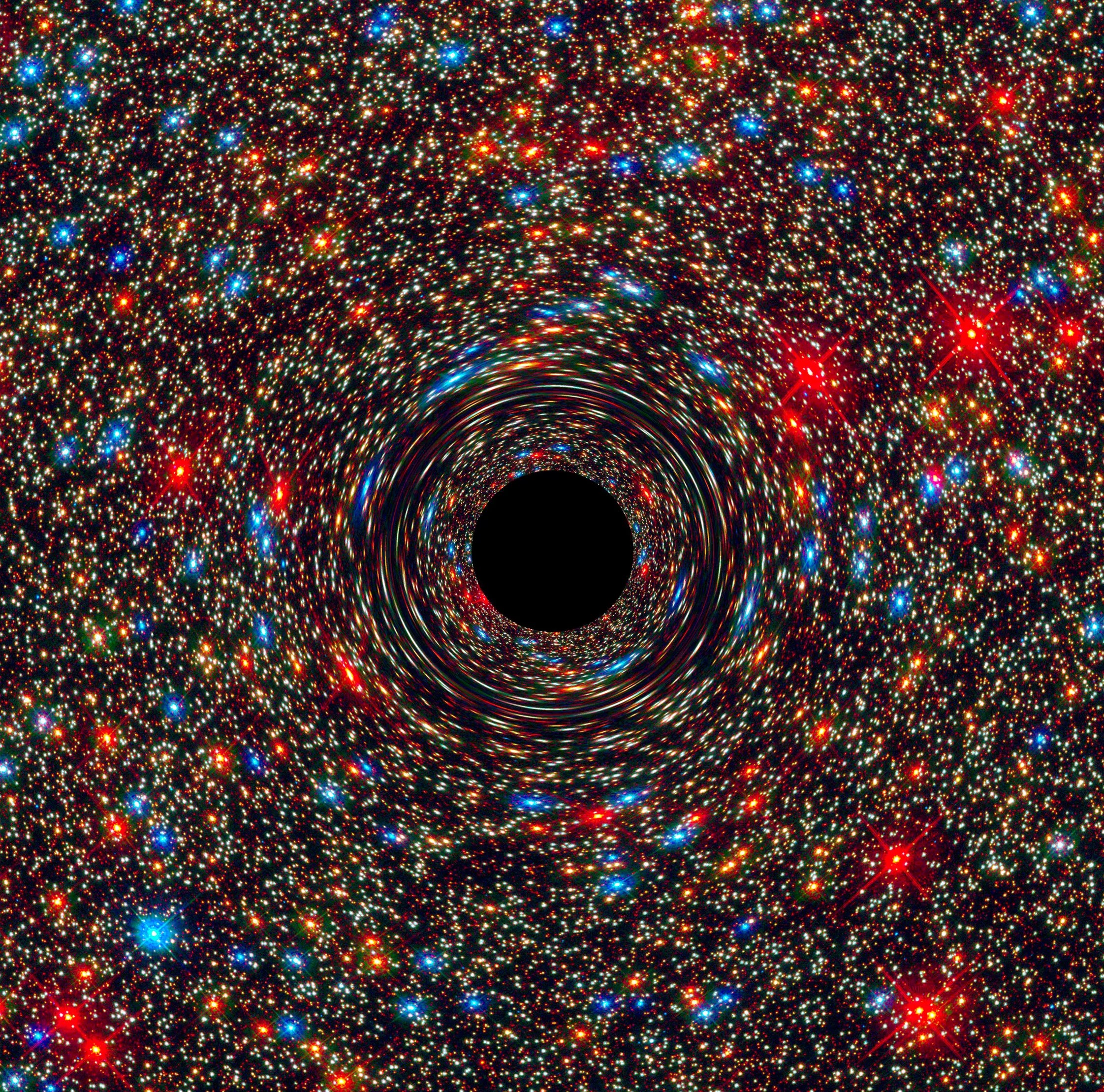 Computer simulation of a supermassive black hole at the core of a galaxy. Center is a black circle. Surrounding the black circle are arcs of red, blue, orange, and white. Further out from the circle are blotches of red, blue, orange, and white representing celestial objects.