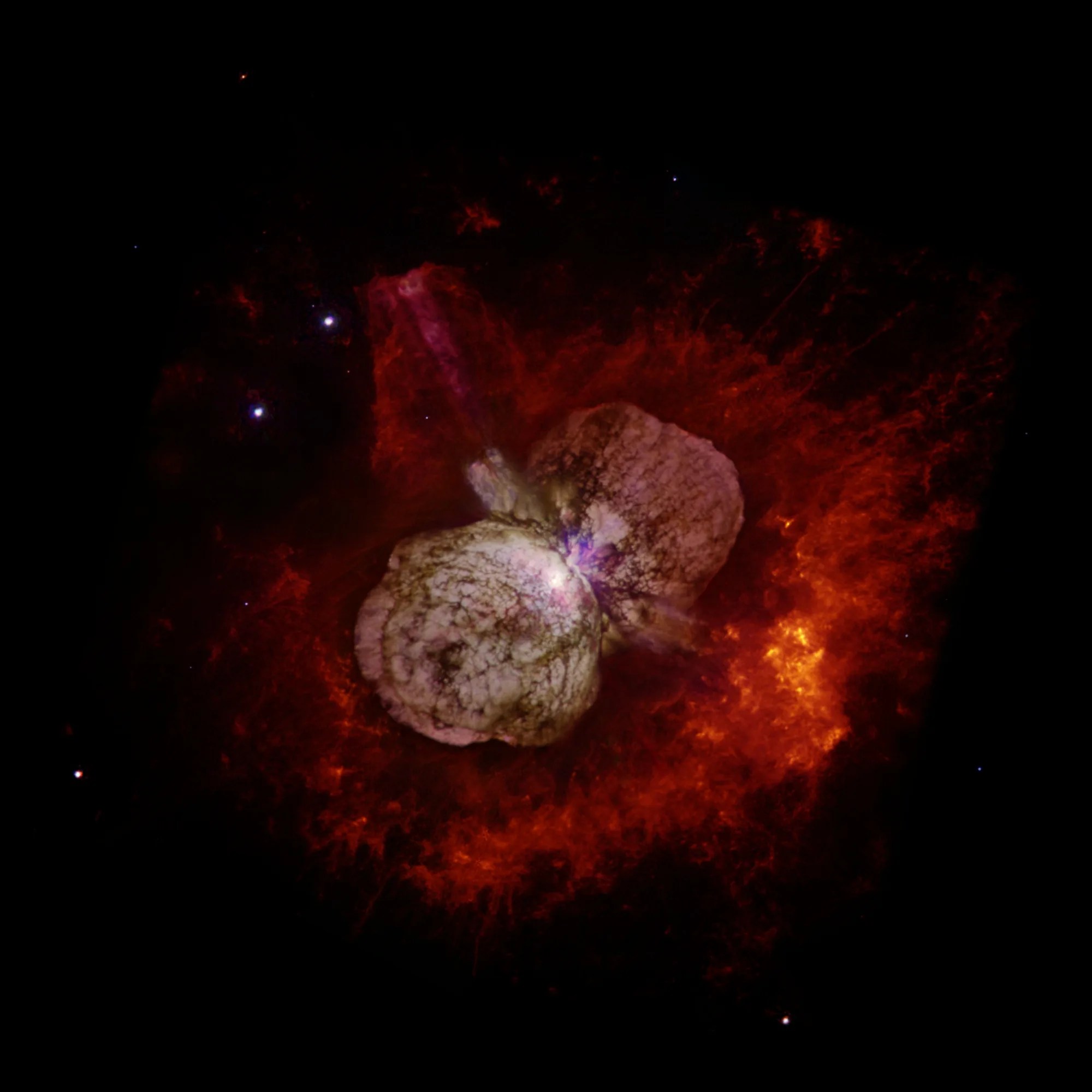 A gray, double-lobed cloud of gas, veined with lanes of dark dust, is in the center of a fiery red-orange nebula.