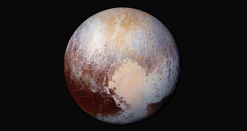 Pluto is reddish and has a heart shape lighter patch in the lower right half of this image from the New Horizons spacecraft.