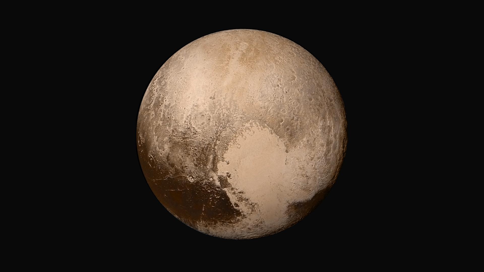 Pluto is reddish and has a heart shape lighter patch in the lower right half of this image from the New Horizons spacecraft.