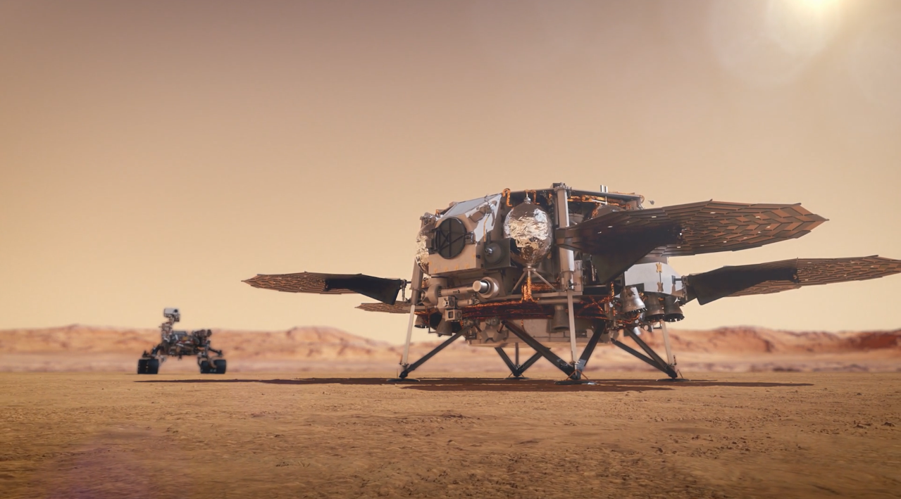 Artist's concept of a lander surrounded by round fuel tanks and circular solar panels on the surface of Mars. A rover at a distance in the background.