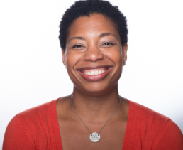 Portrait photo of a smiling woman in a red sweater.