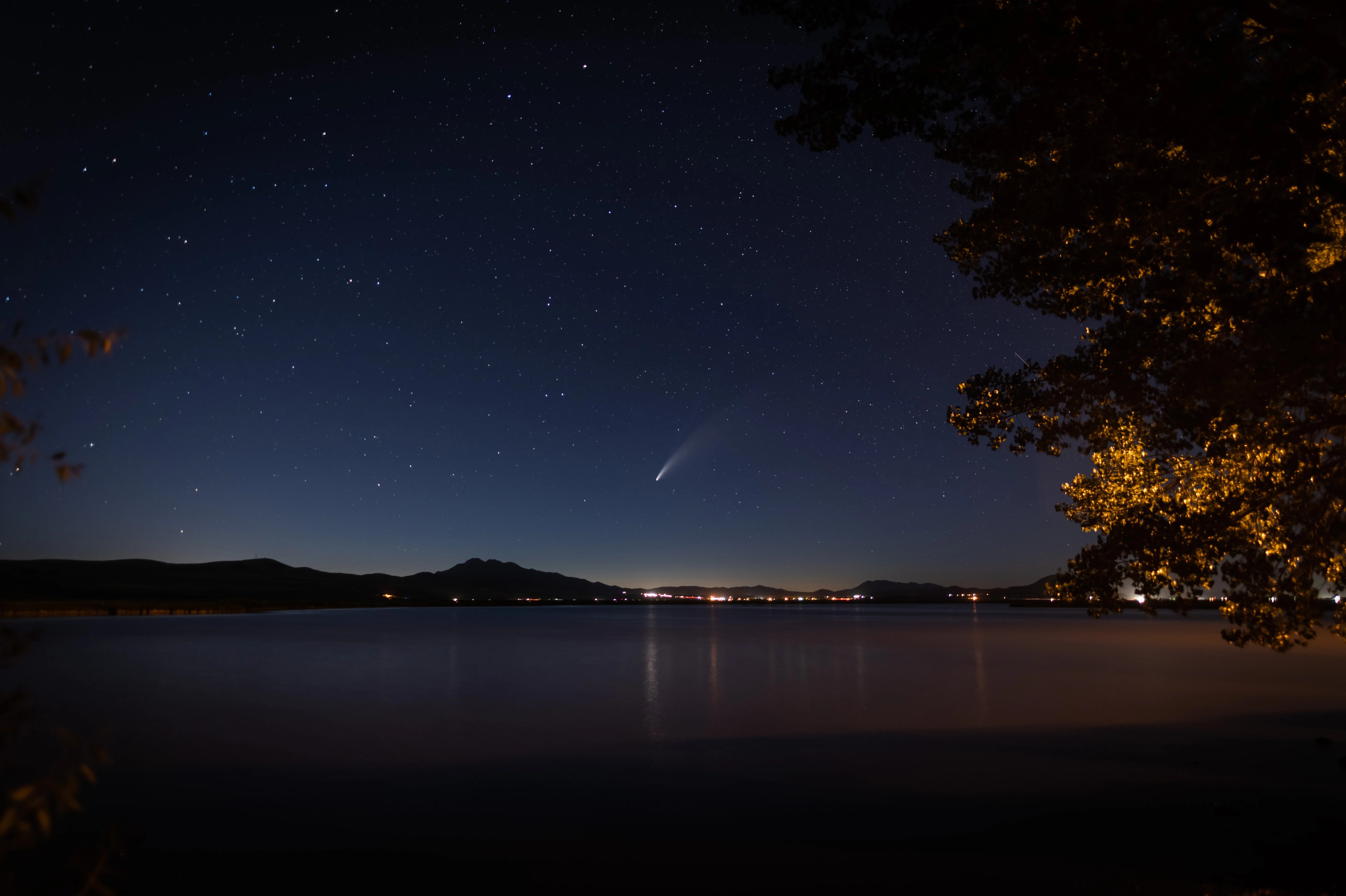 A comet in the sky over a city.