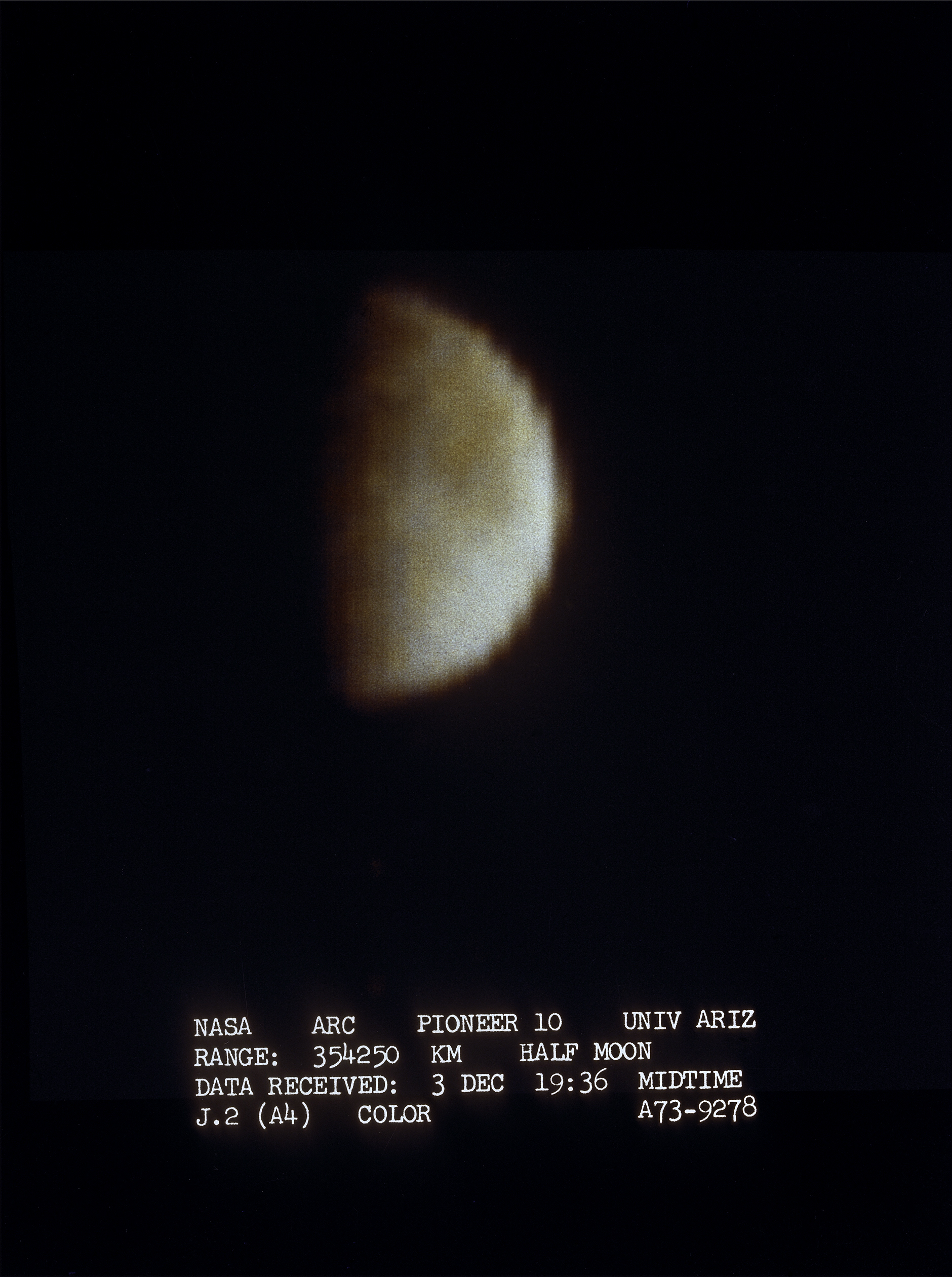 Europa looks like a partially lit fuzzy, yellow-orange orb in this image from Pioneer 10.