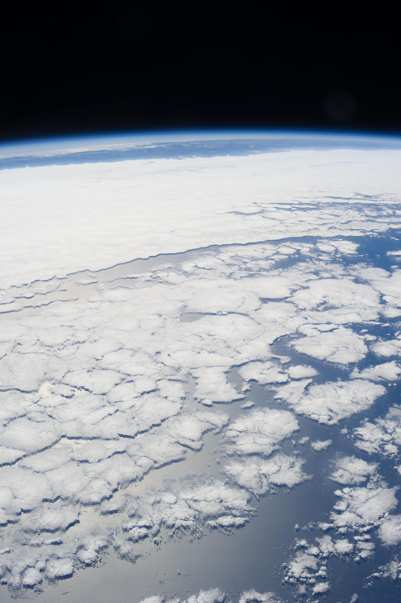 The earth with clouds and ice visible.  Many Open Science success stories relate to Open Science.