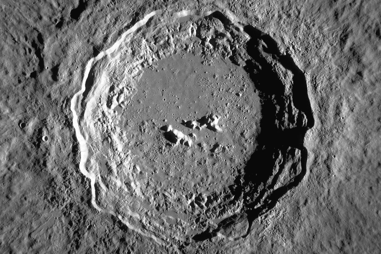 Huge, round crater, with concentric ledges around its edge, and (relatively) small peaks near the middle of its floor.