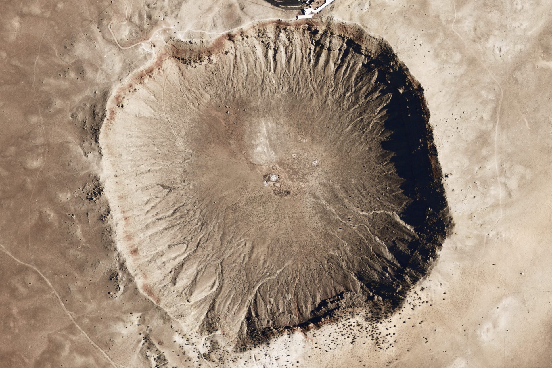 Huge, round crater, with evidence of erosion around its edge.