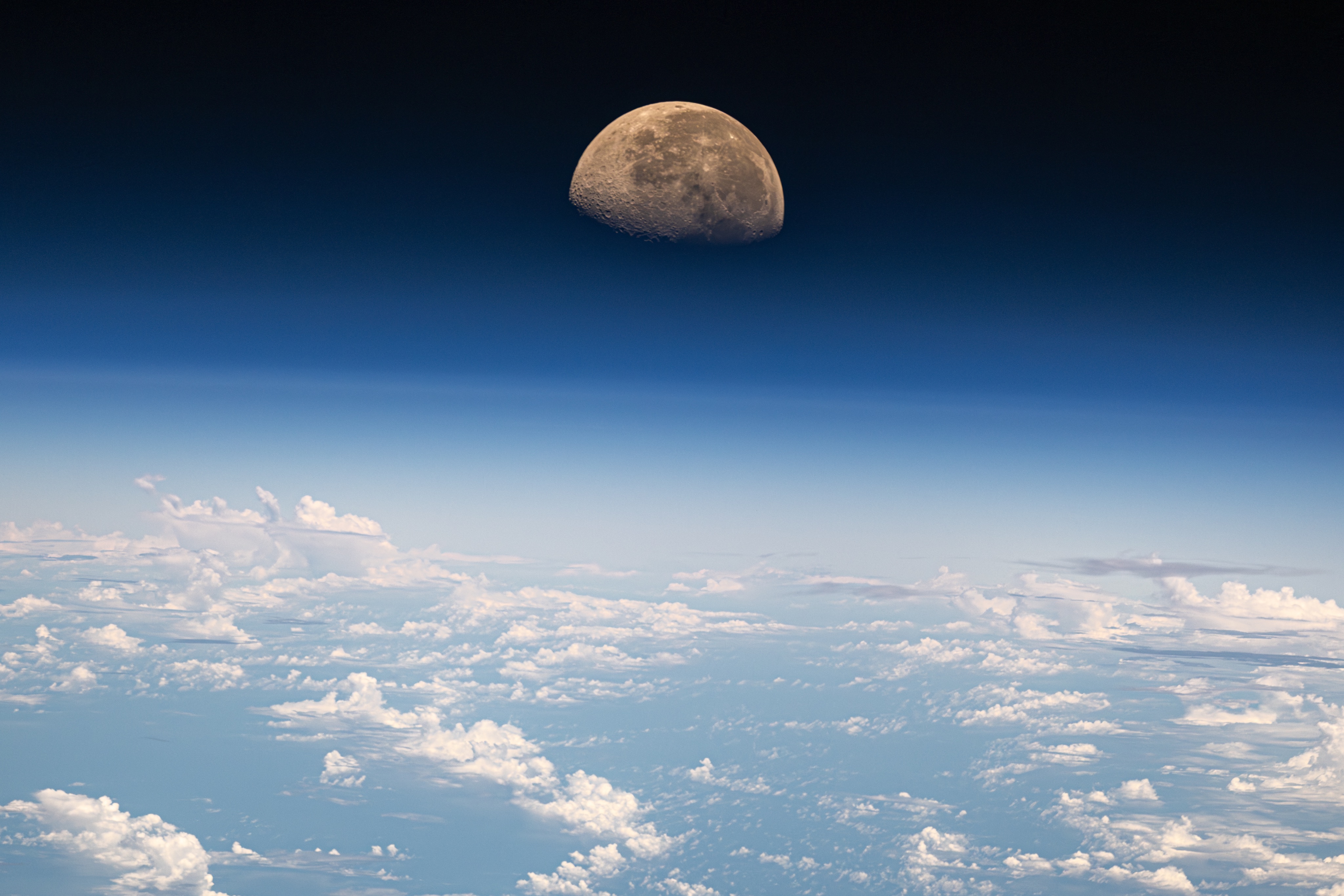 Photo of the Moon above Earth's clouds.