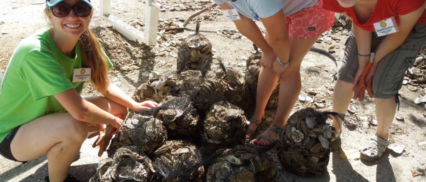 3 summer interns compete in Oyster Olympics, posing for a picture