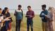 A group look at photos and clipboards in Bangladesh A group look at photos and clipboards in Bangladesh