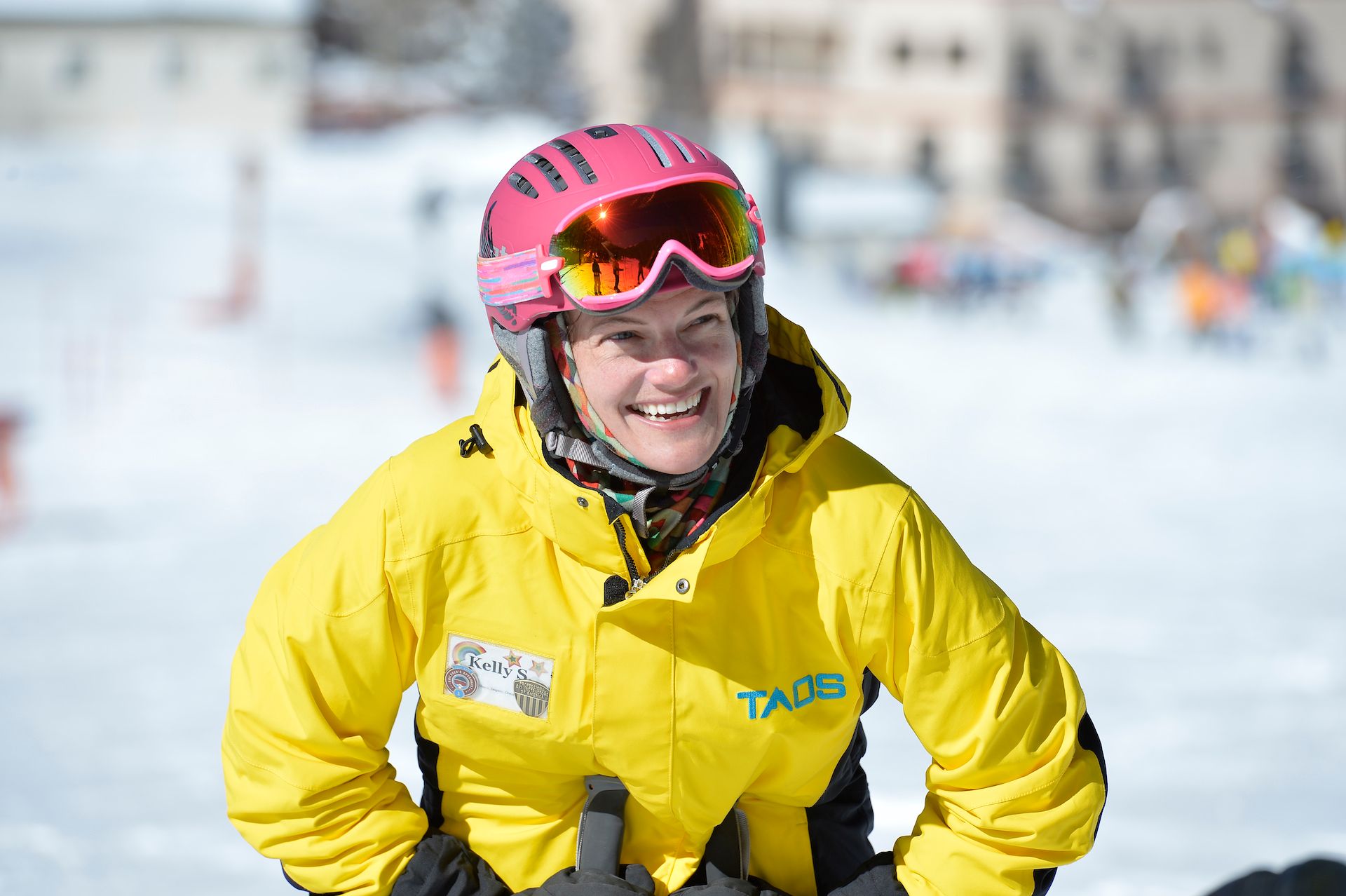 Snowsports instructor listening excitedly to students at Taos Ski Valley.