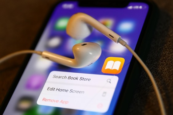 Apple Books icon displayed on a phone with headphones