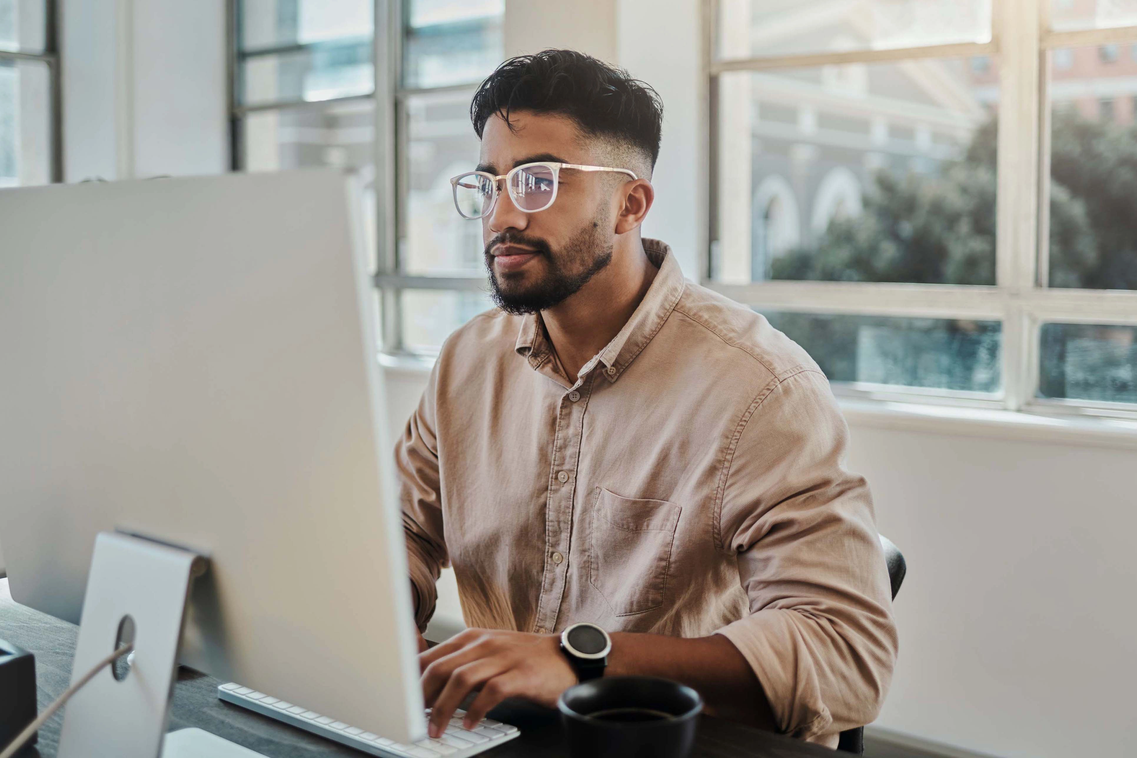 Person typing on desktop 