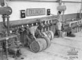 Australian troops using captured Italian 200 L drums and filling equipment, Tobruk, Libya 1941