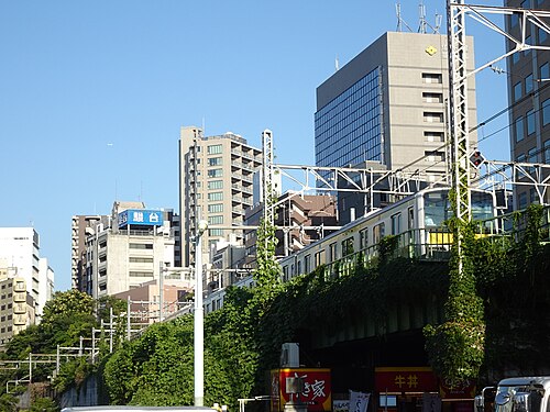 Chūō–Sōbu Line Local Train with yellow line body, at neighborhood of JR East Suidōbashi Station, Tokyo, Japan.