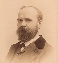 Portrait photograph of Benjamin Tucker, wearing a beard