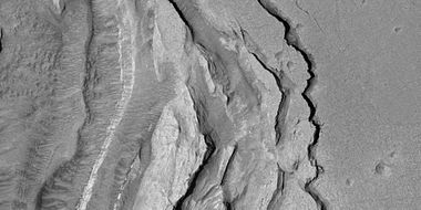 Tilted layers formed when ground collapsed, as seen by HiRISE under HiWish program