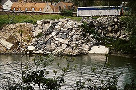 Aa river, its banks shored up with heavy rubble