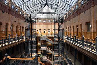 Interior of the Bradbury Building, with its exposed staircases and free-standing hydraulic elevators, Los Angeles, USA, by George Herbert Wyman, 1889-1893[246]