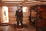 Replica of nao Victoria, Magellan in its cabin.