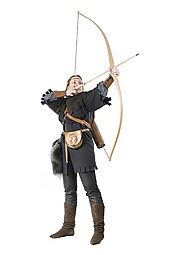 a woman holding a partly drawn longbow