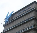 The upper floors of the Main Building's eastern wing, housing library stacks and showing the University emblem.