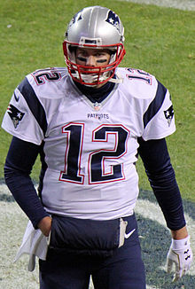 Tom Brady on the field in uniform