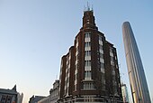 The Gulf Building (or Po Hai Building), built in 1937, was the tallest building in Tientsin before the 1960s. Tianjin World Financial Center can be seen behind.