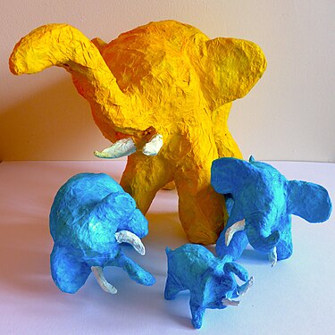 Papier mache elephants including recycled packaging materials.