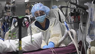 A nurse caring for a patient with COVID-19 in an intensive care unit