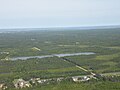 Les bassins du parc industriel. Le parc éolien de Lamèque est visible au loin.