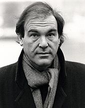 Black-and-white picture of Oliver Stone looking to the camera.