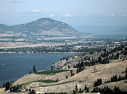 An aerial view of Penticton; Skaha Lake can be seen in the foreground, while Okanagan Lake is visible in the background. Penticton Regional Airport's runway can also be seen.