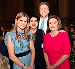 Nicole Covert (in the blue dress), Luci Baines Johnson (in the black dress) and John Covert (wearing suit) (30 October 2019)