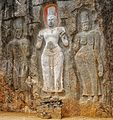 Avalokitesvara (the bodhisattva of compassion). To the left of this white-painted figure is a female figure thought to be his consort, Bodhisattva Tara. Local legend says the third figure represents Prince Sudhana.