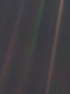 Dark gray and black static with colored vertical rays of sunlight over part of the image. A small pale blue point of light is barely visible.