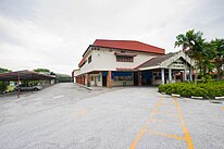 The outside of Yuk Chai's former hall, including parking lot.