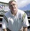 Photo of Sherman wearing a Packers polo shirt in a stadium