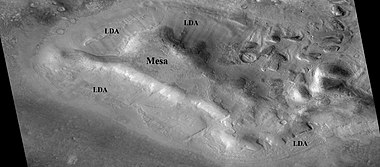 Lobate debris aprons (LDAs) around a mesa, as seen by CTX Mesa and LDAs are labeled so one can see their relationship. Radar studies have determined that LDAs contain ice; therefore these can be important for future colonists of Mars. Location is Ismenius Lacus quadrangle.