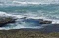 2015-02-19 Waves break on the rocks at Bamburgh.