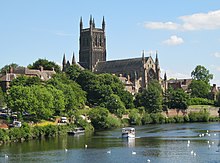 View of the cathedral with a large tower seen across the river.