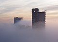 2014-10 Residential high-rises poke through low fog in Canary Wharf.