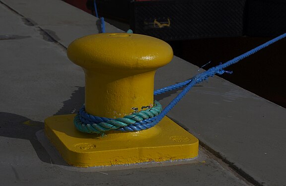 Yellow bollard with blue rope on a quay of Helgoland Island, Germany