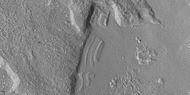 Close view of dipping layers along a mesa wall, as seen by HiRISE under HiWish program