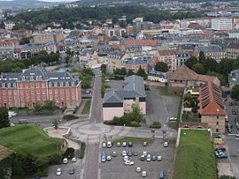 Collection of European style building stretching to the horizon interspersed with hills and trees