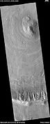 Wide view of dipping layers, as seen by HiRISE under HiWish program. Gullies are also visible at the bottom of the image.